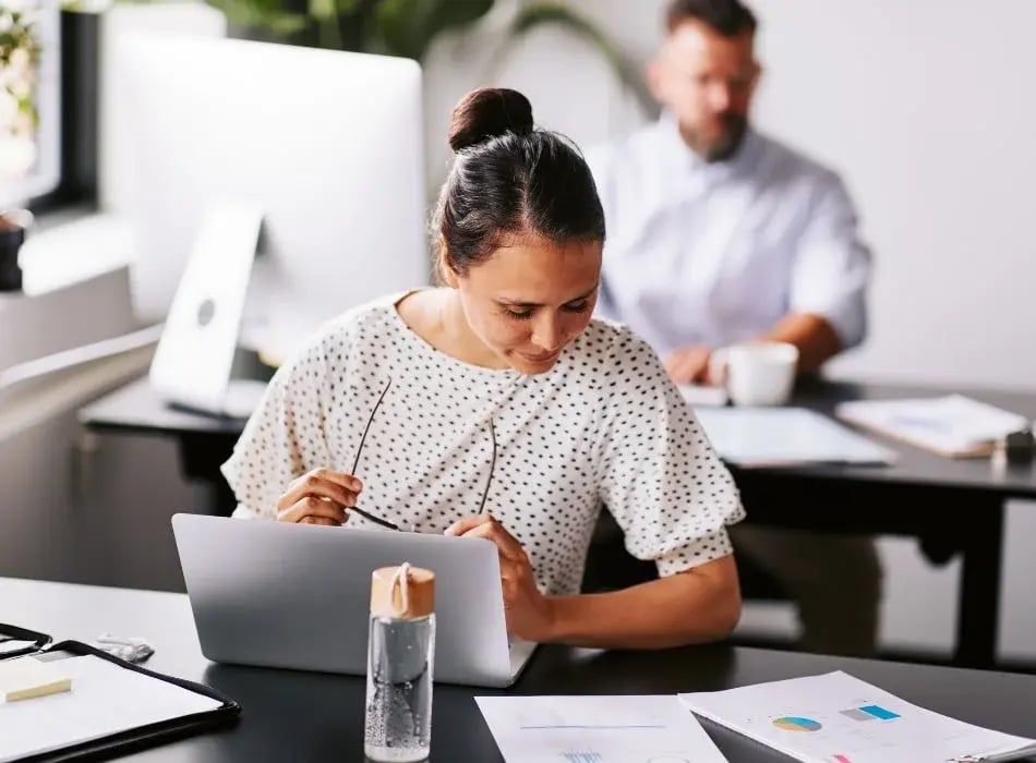 woman at desk reading paperwork